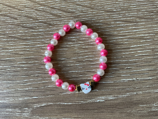 Pink and white ‘Hello Kitty’ bracelet with two gold stars